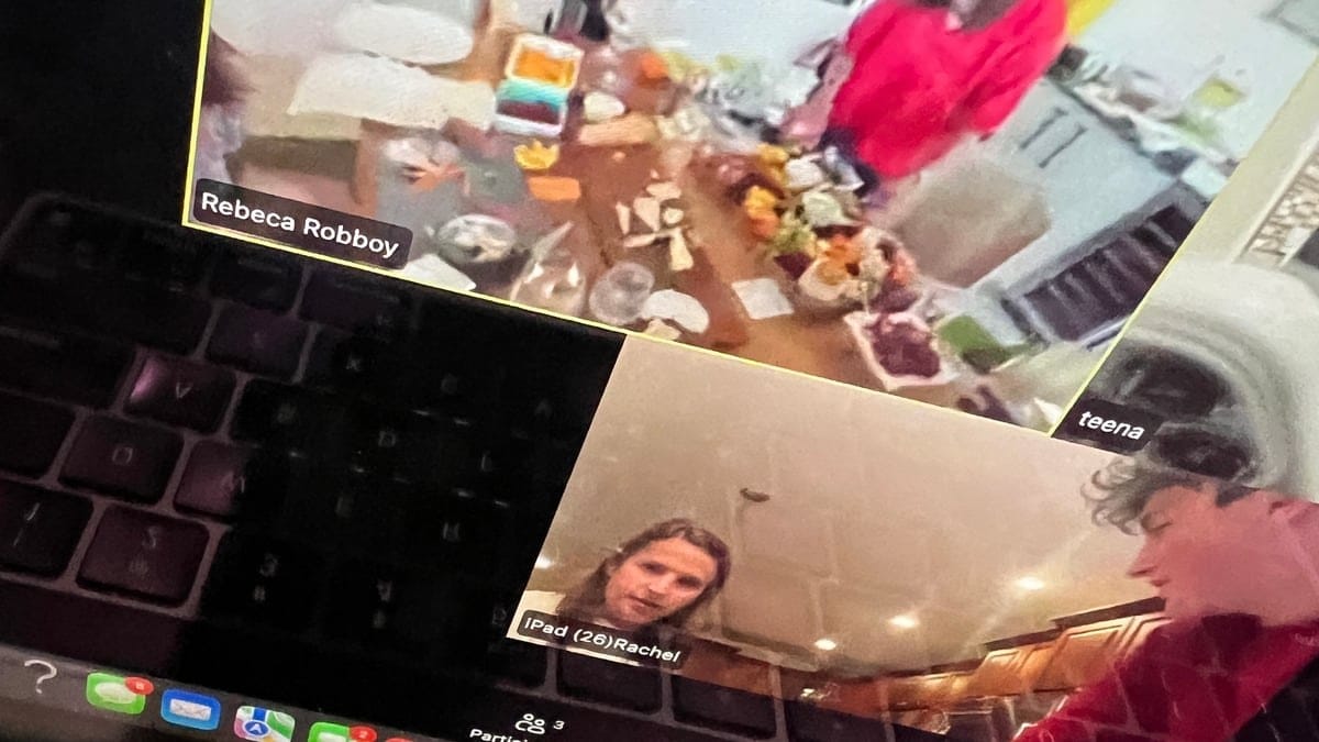 A remote team on a video call during a virtual team building session, shown on a laptop screen